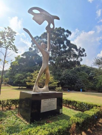 Estátua de pessoa na grama  Descrição gerada automaticamente com confiança média 